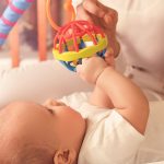 Bebê brincando com um brinquedo colorido